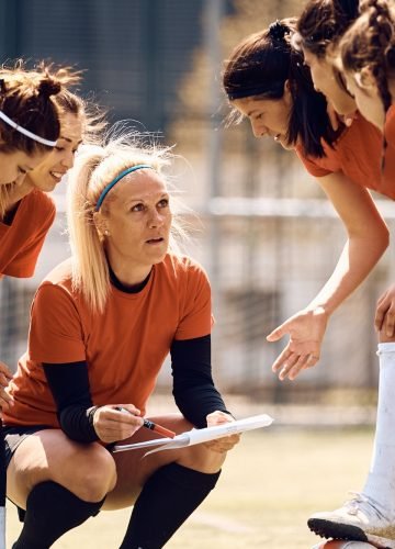 female-soccer-team-and-their-coach-going-through-game-plan-on-football-pitch-.jpg female-soccer-team-and-their-coach-going-through-game-plan-on-football-pitch-.jpg